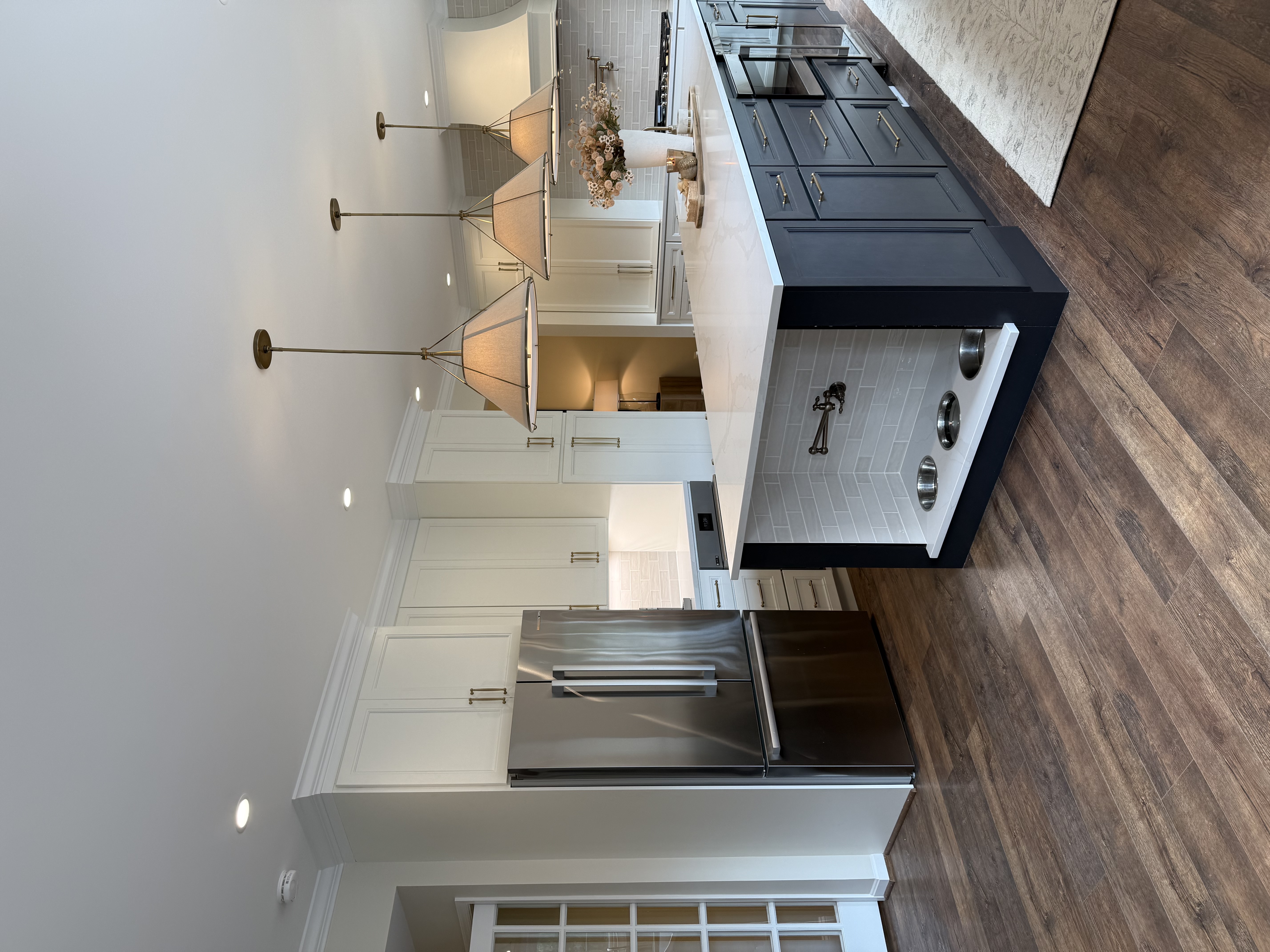 Kitchen remodel — stainless appliances with white and navy cabinetry