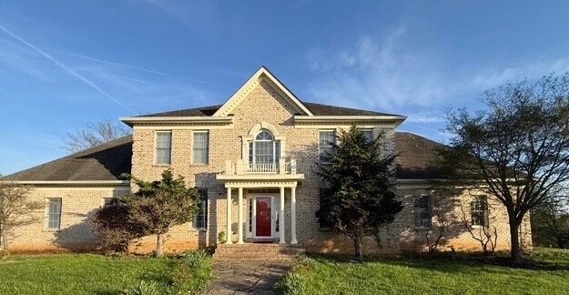 Home exterior before home prep — dated brick facade